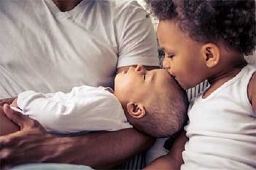 Father Holding Baby with Daughter