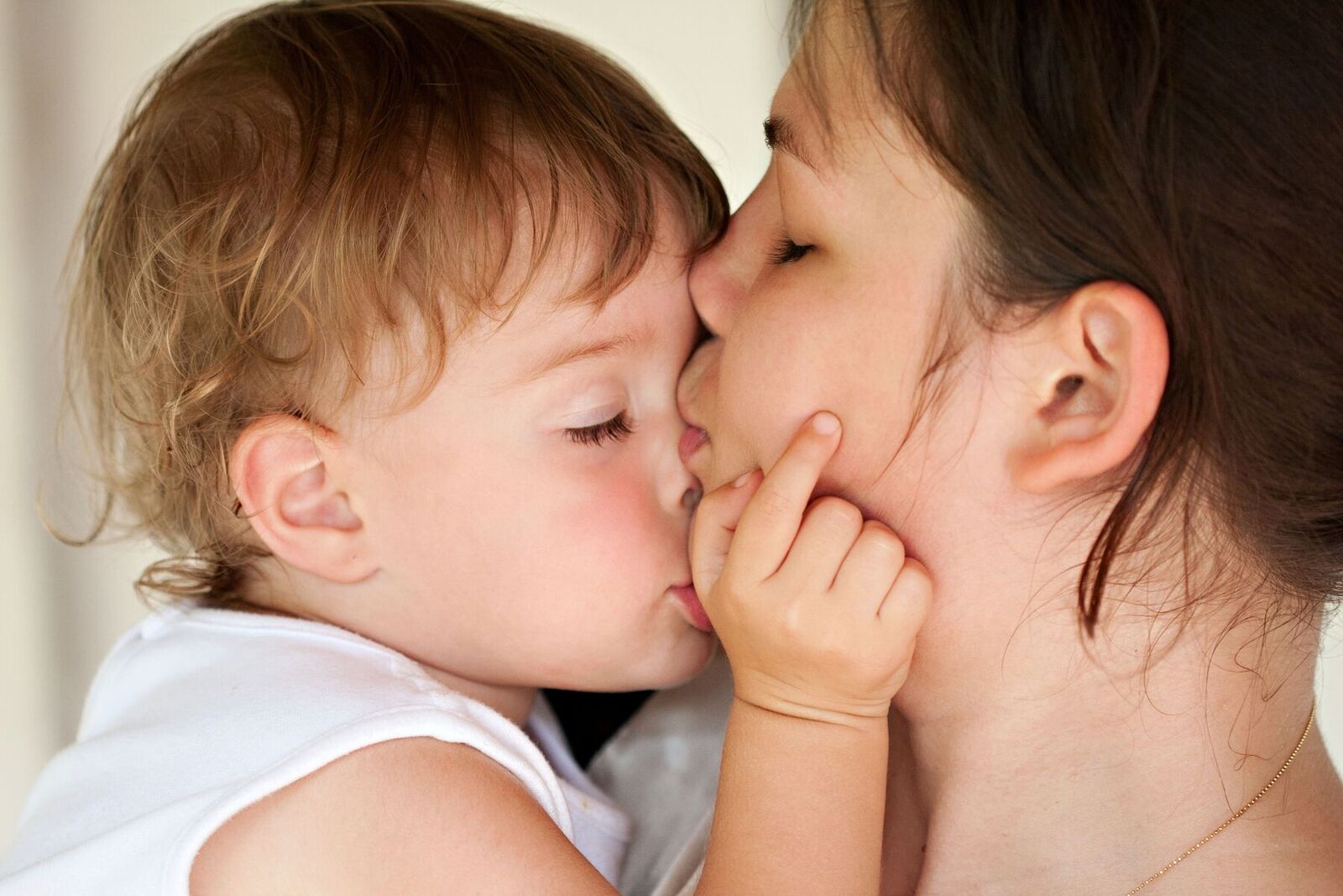 Mother Kissing Child