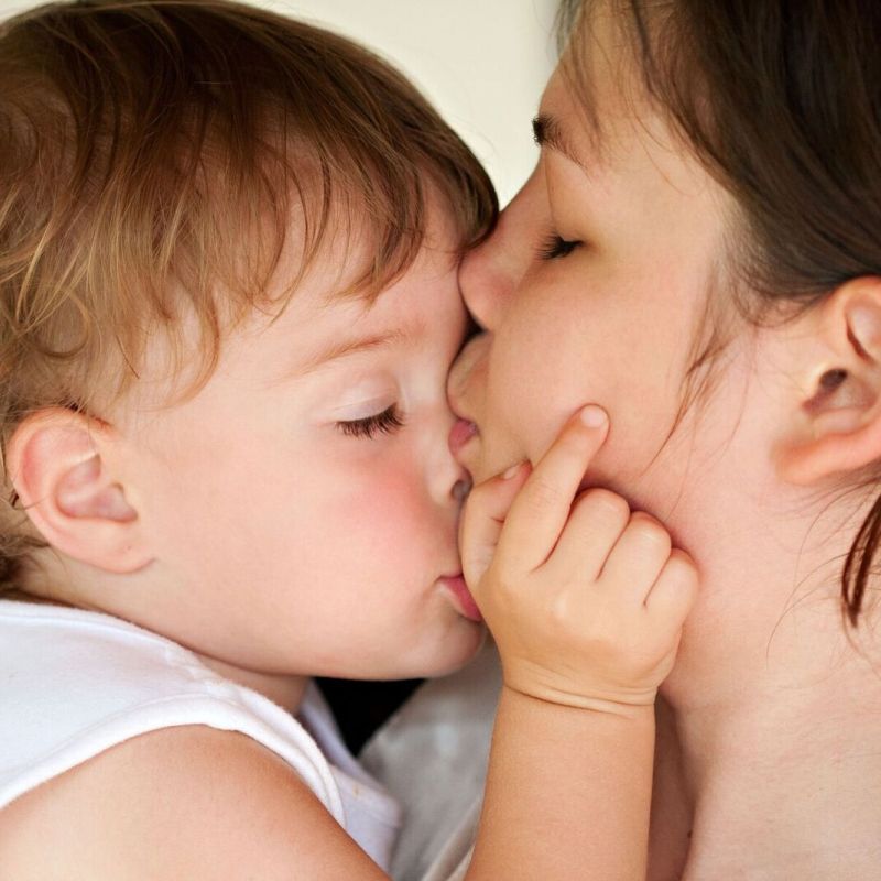 Mother Kissing Child